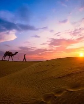 /uploads/gallery/459a72e3-9282-4a1e-ad13-76bb05cc5e27_indian-cameleers-camel-driver-with-camel-silhouettes-in-dunes-on-sunset-jaisalmer-rajasthan-india-photo.jpg